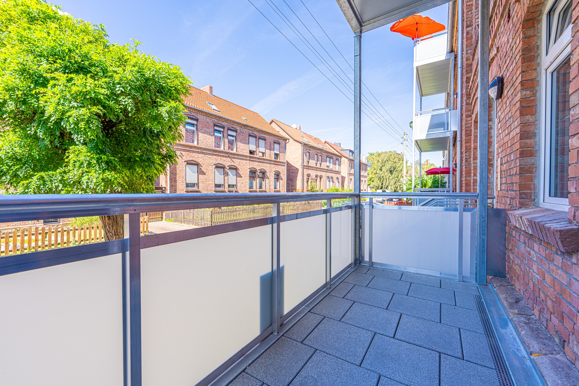 Moderner Balkon mit Blick auf Backsteinhäuser
